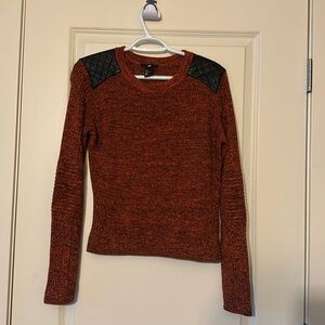 Burnt orange sweater with faux leather accent on shoulder.